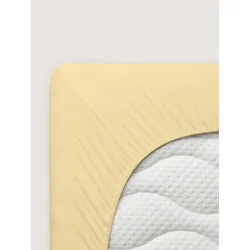 Le drap-housse en jersey extensible Pure  Schlafgut jaune