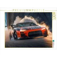 Calvendo Puzzle EIN schwarz-orangefarbener Rennwagen fährt auf Einer Rennstrecke